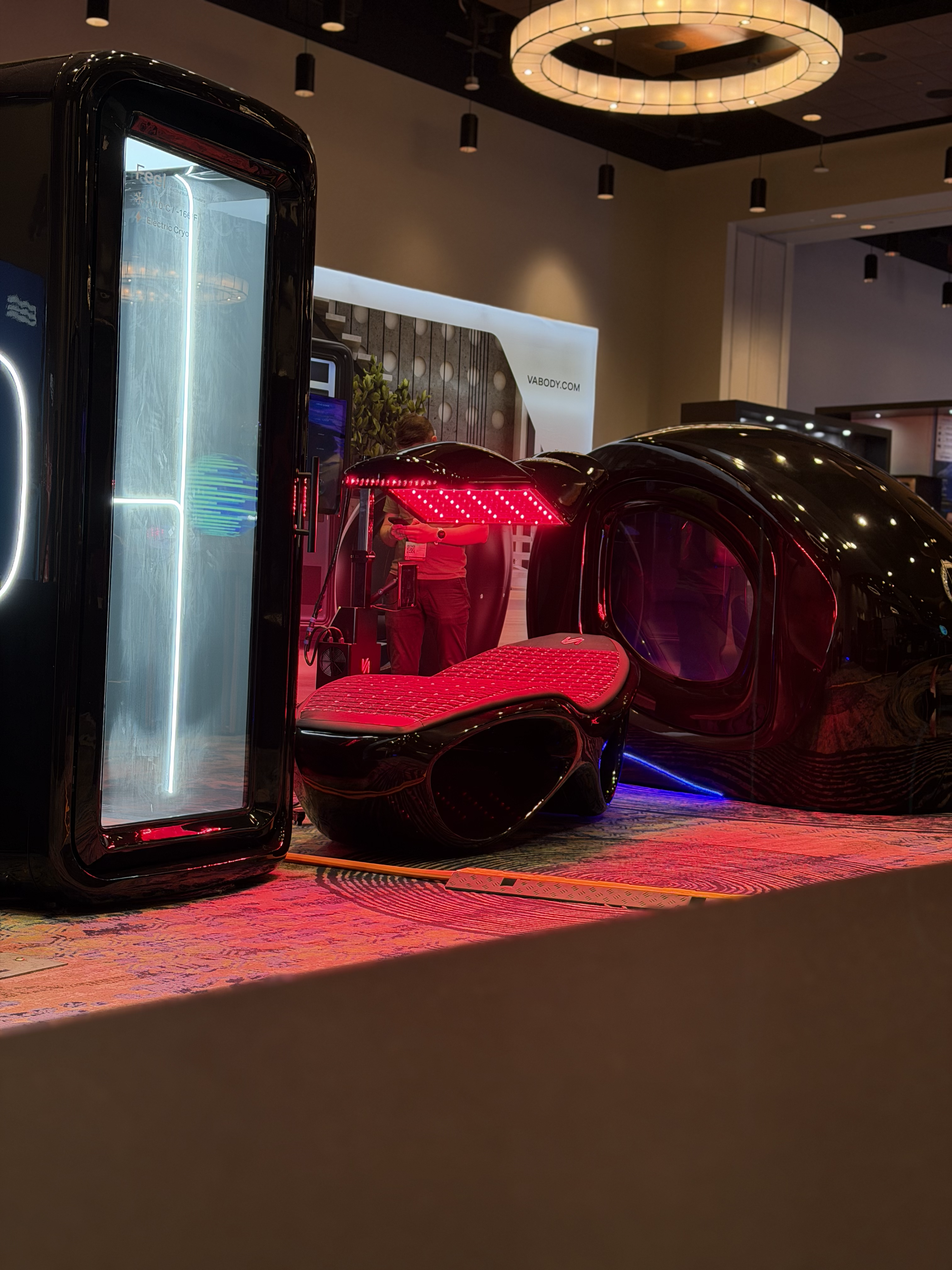 TSB 360 booth at CryoCon 2026 featuring the Cryo Q One chamber and NextGen Pro 2.0 LED bed with red light therapy