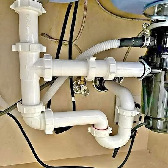 New kitchen sink drain plumbing with garbage disposal installed by a Rockwall plumber