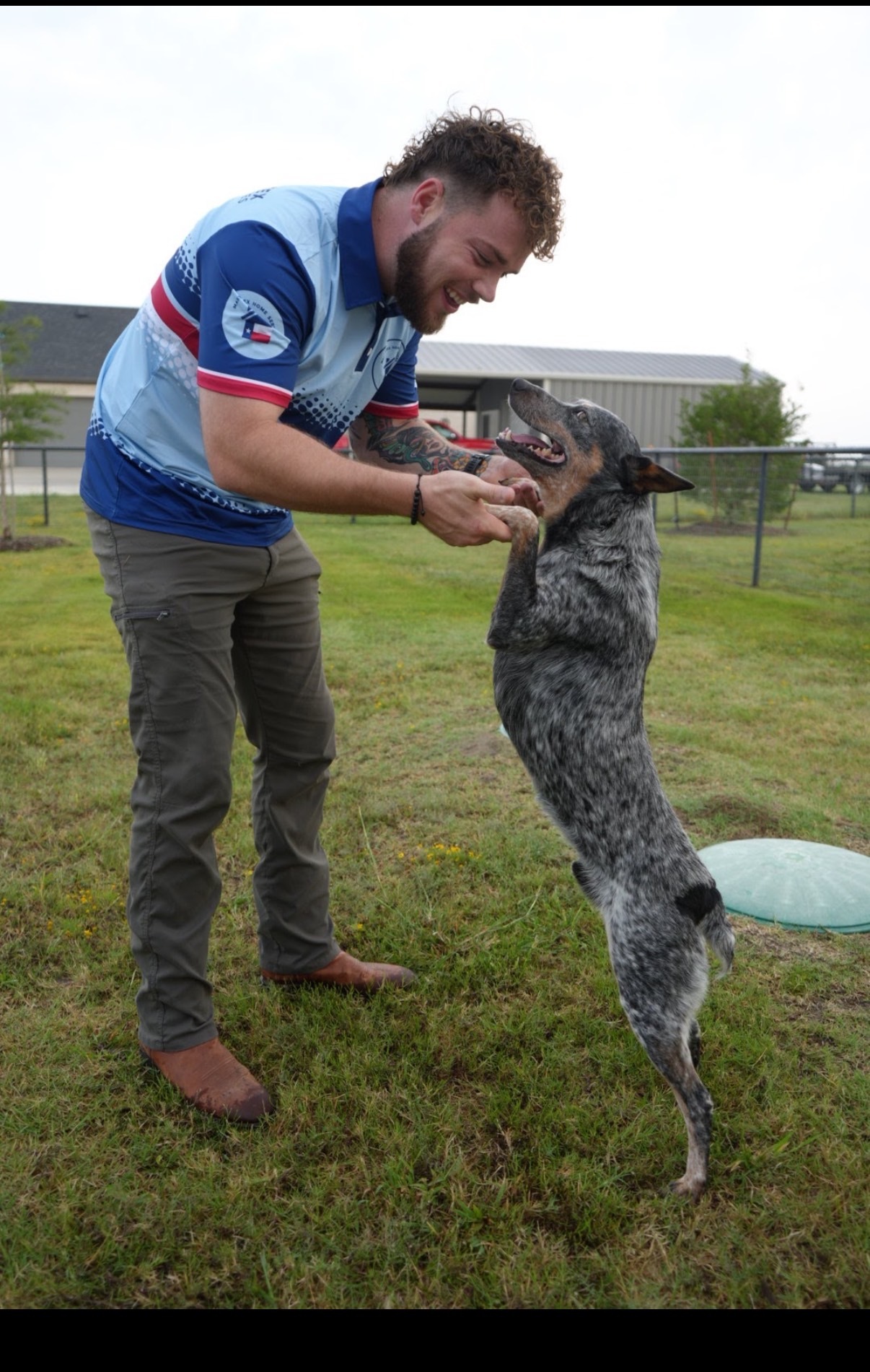 Connor Kingsley playing with his dog