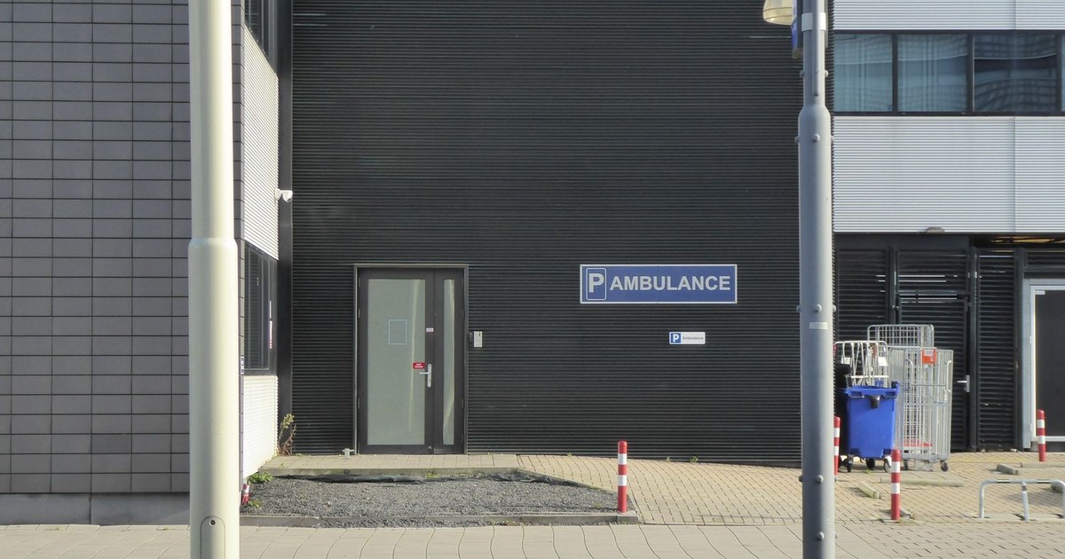 Modern medical building exterior with ambulance parking entrance